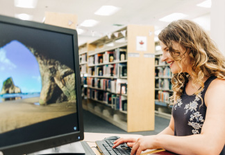 Woman using a computer in a library
