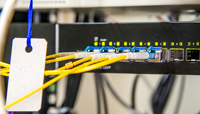 Several fibre optic connectors used to join optical fibre cables for high-speed data transmission.